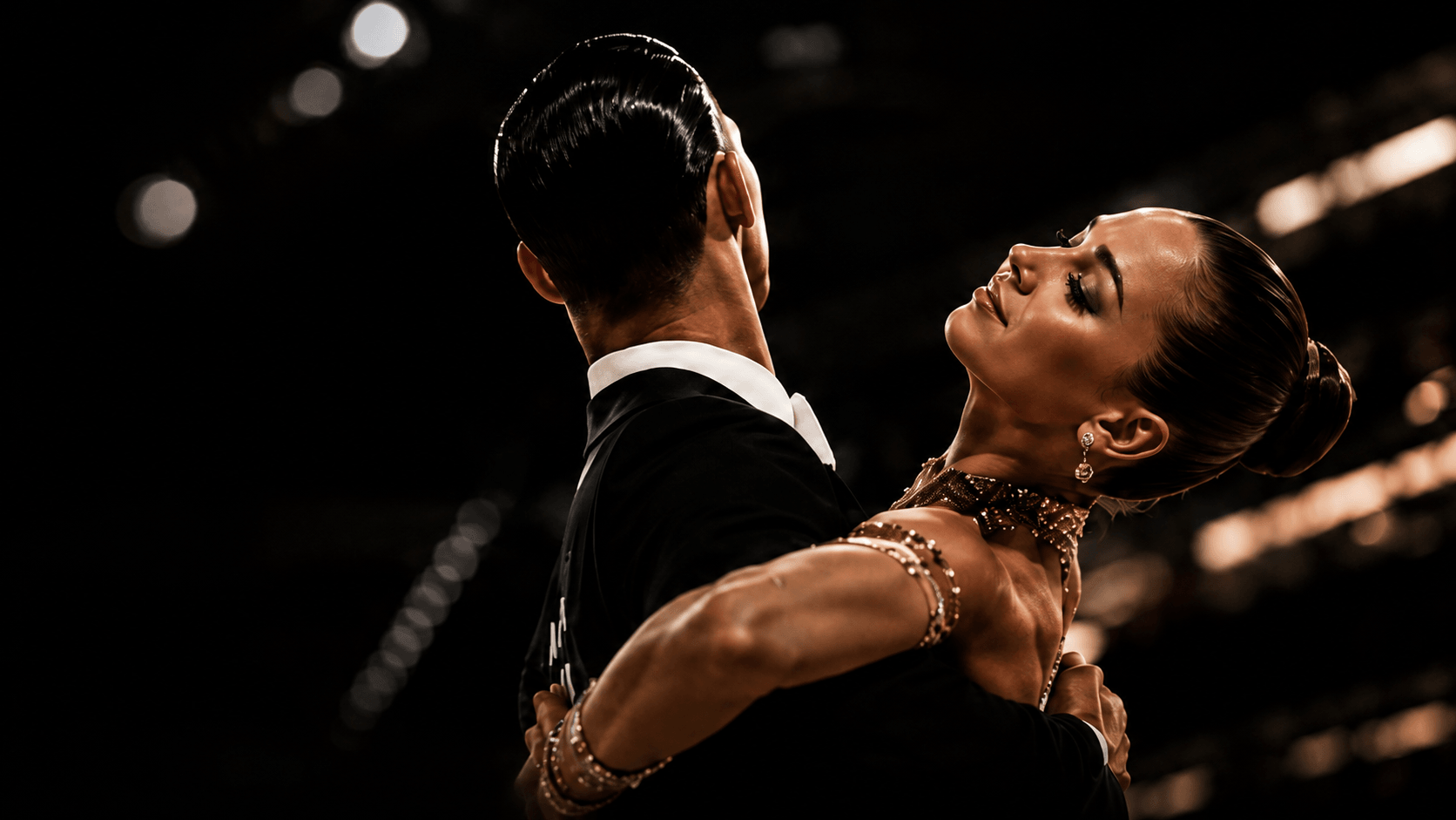 A DanceSport couple mid-performance on the competition floor.