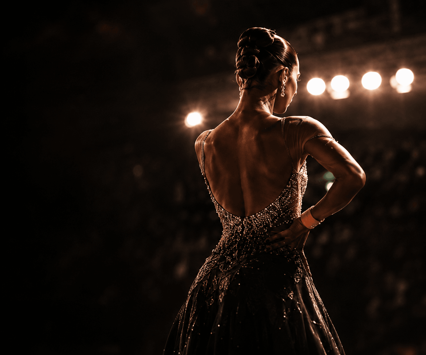 A dancer in a quiet moment before stepping onto the floor.